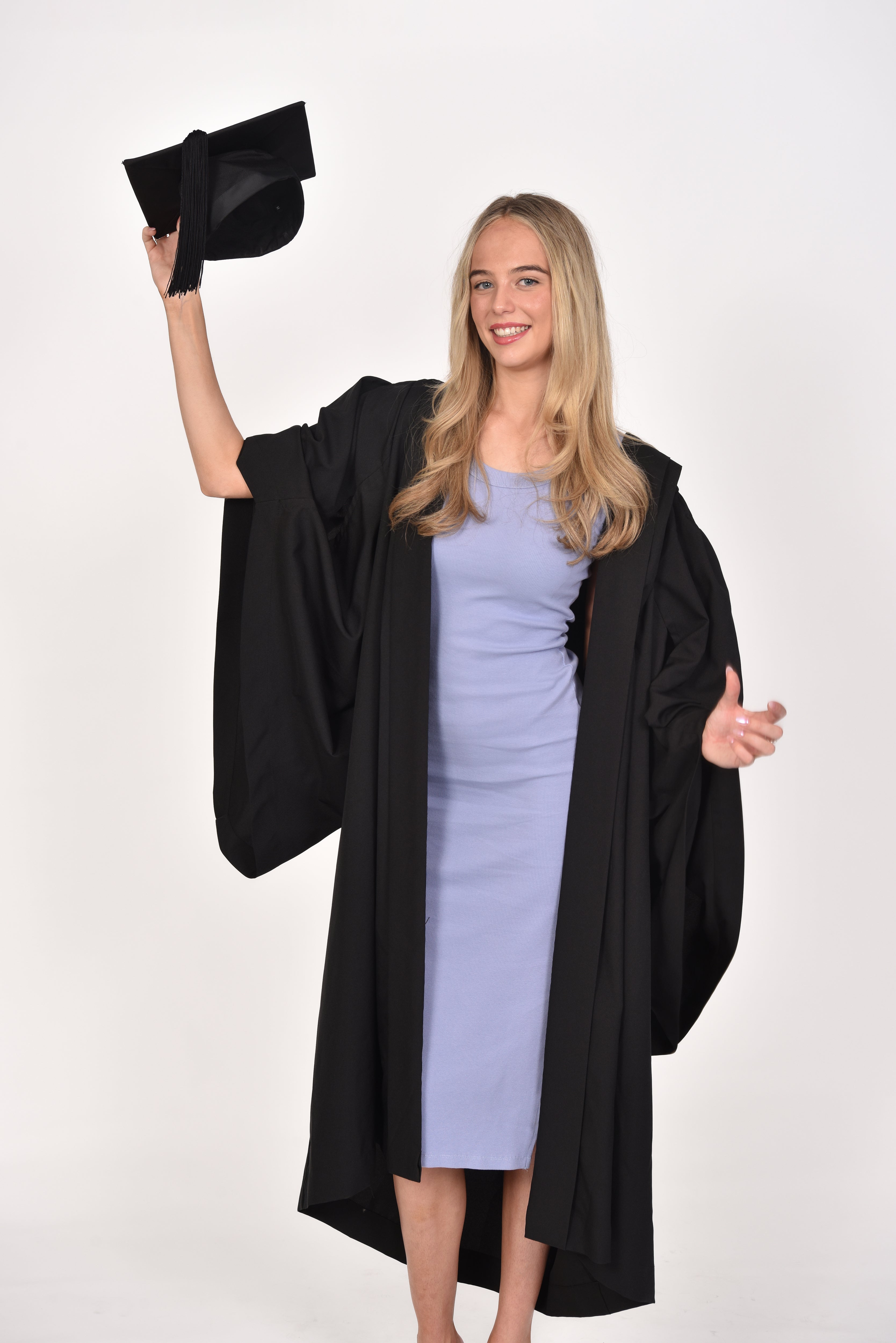 Graduate throwing Mortarboard Hat into the air in celebration